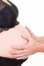 Man hands touching the belly of his pregnant woman listening to the baby moving Royalty Free Stock Photo