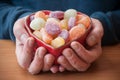 Man hands with a traditional candies in a shaped hear