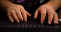 Man hands typing on laptop keyboard.