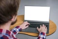 Man hands typing on laptop keyboard with white blank screen - mockup image Royalty Free Stock Photo