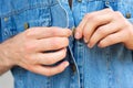 Man hands unbuttoning denim blue shirt Royalty Free Stock Photo