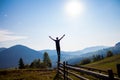 Man with hands up on top of mountains with blue sky Royalty Free Stock Photo