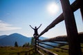 Man with hands up on top of mountains with blue sky Royalty Free Stock Photo