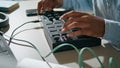 Man hands using console keyboard closeup. Unknown dj pushing buttons mixing song Royalty Free Stock Photo
