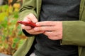 Man hands using mobile cell phone outdoors. Social media concept. Closeup of male hand holding and using modern smartphone. Royalty Free Stock Photo