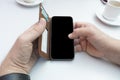Man hands using mobile phone on a table with coffee with copy space Royalty Free Stock Photo