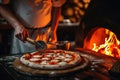 Chef hands using pizza cutter knife over hot italian pizza. Fast food concept. Royalty Free Stock Photo