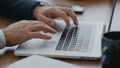 Man hands using touchpad on laptop typing documents at company office close up Royalty Free Stock Photo