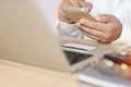 Man hands in white shirt sitting and looking credit card and using laptop computer on table for online payment or shopping online Royalty Free Stock Photo