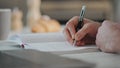 Man hands writing notepad at home close up. Student studying noting information Royalty Free Stock Photo