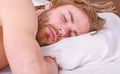 Man handsome guy lay in bed. Get adequate and consistent amount of sleep every night. Expert tips on sleeping better