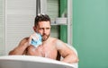 Man handsome muscular guy relaxing in bath. Spa wellness concept. Taking bath with soap suds. Treating yourself with hot Royalty Free Stock Photo