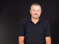 Man handsome portrait in black shirt smiling face on dark Background Royalty Free Stock Photo