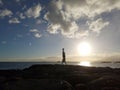 Man Handstand on Rocks along the water at sunset