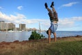 Man Handstanding along shore of Magic Island