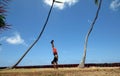 Man Handstanding in the grass along cliff shore next to shallow