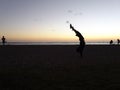 Man Handstands on Ala Moana Beach at Dusk Royalty Free Stock Photo