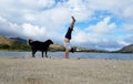 Man Handstands on beach with black dog next to him in Hawaii Kai Royalty Free Stock Photo