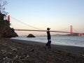 Man Handstands on beach in front of the Golden Gate Bridge Royalty Free Stock Photo