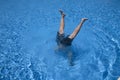 Man handstands in a pool Royalty Free Stock Photo