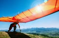 Man with hang-glider starting to fly from the hill top Royalty Free Stock Photo