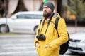 Man hanging film camera on neck at walking street and travel concepts