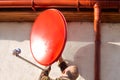 A man hangs a satellite TV dish on the wall of his house. Multichannel television in rural areas Royalty Free Stock Photo