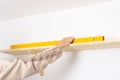 A man hangs a shelf in an apartment Royalty Free Stock Photo