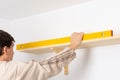 A man hangs a shelf in an apartment Royalty Free Stock Photo
