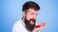 Man happy face open mouth with beard eats strawberries. Want to try my berry Hipster bearded holds strawberries on palm