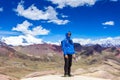 A man happy, stands on top of the Rainbow Mountains Of Peru. Peruvian Andes. Ausangate mountain.