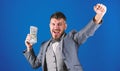 Man happy winner rich hold pile of dollar banknotes blue background. Easy cash loans. Win lottery concept. Businessman Royalty Free Stock Photo