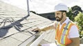 man in a hard hat, holding a clipboard, standing on the steps of an old rundown house. Royalty Free Stock Photo