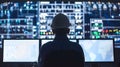 Man in hard hat sitting at computer screen, utilizing technology
