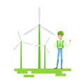 Man In Hard Hat Standing Next To Wind Power Turbines , Contributing Into Environment Preservation By Using Eco-Friendly