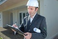 man with hard helmet and clipboard