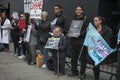 A man in a hare suit is holding a poster. Anti fur protest during the London Fashion Week. outside Eudon Choi.