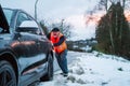 A man has a car breakdown on a country road