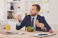 Man has healthy business lunch in modern office interior