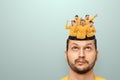 The man has little people dancing in his head. The concept of cheerful thoughts, euphoria, the brain rejoices, endorphins, Royalty Free Stock Photo