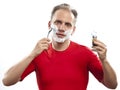 Man has a shave- with the razor and a small brush Royalty Free Stock Photo