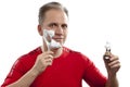 Man has a shave- with the razor and a small brush Royalty Free Stock Photo