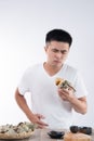 A man has a stomachache after eating delicious zongzirice dumpling on Dragon Boat Festival, Asian traditional food Royalty Free Stock Photo