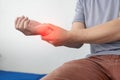 Man has wrist pain from using smartphone or computer for a long time, arthritis, ergonomics, Royalty Free Stock Photo