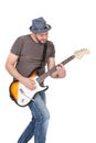 Man with hat and beard play on electric guitar with enthusiasm. Isolated on white Royalty Free Stock Photo