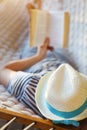 Man in hat in a hammock with book on a summer day Royalty Free Stock Photo