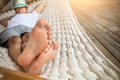 Man in hat in a hammock on a summer day Royalty Free Stock Photo