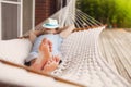 Man in hat in a hammock on a summer day Royalty Free Stock Photo