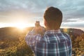 Man in a hat making a selfi at sunset .Guy making a selfi with a smartphone Royalty Free Stock Photo