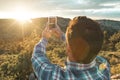 Man in a hat making a selfi at sunset .Guy making a selfi with a smartphone Royalty Free Stock Photo